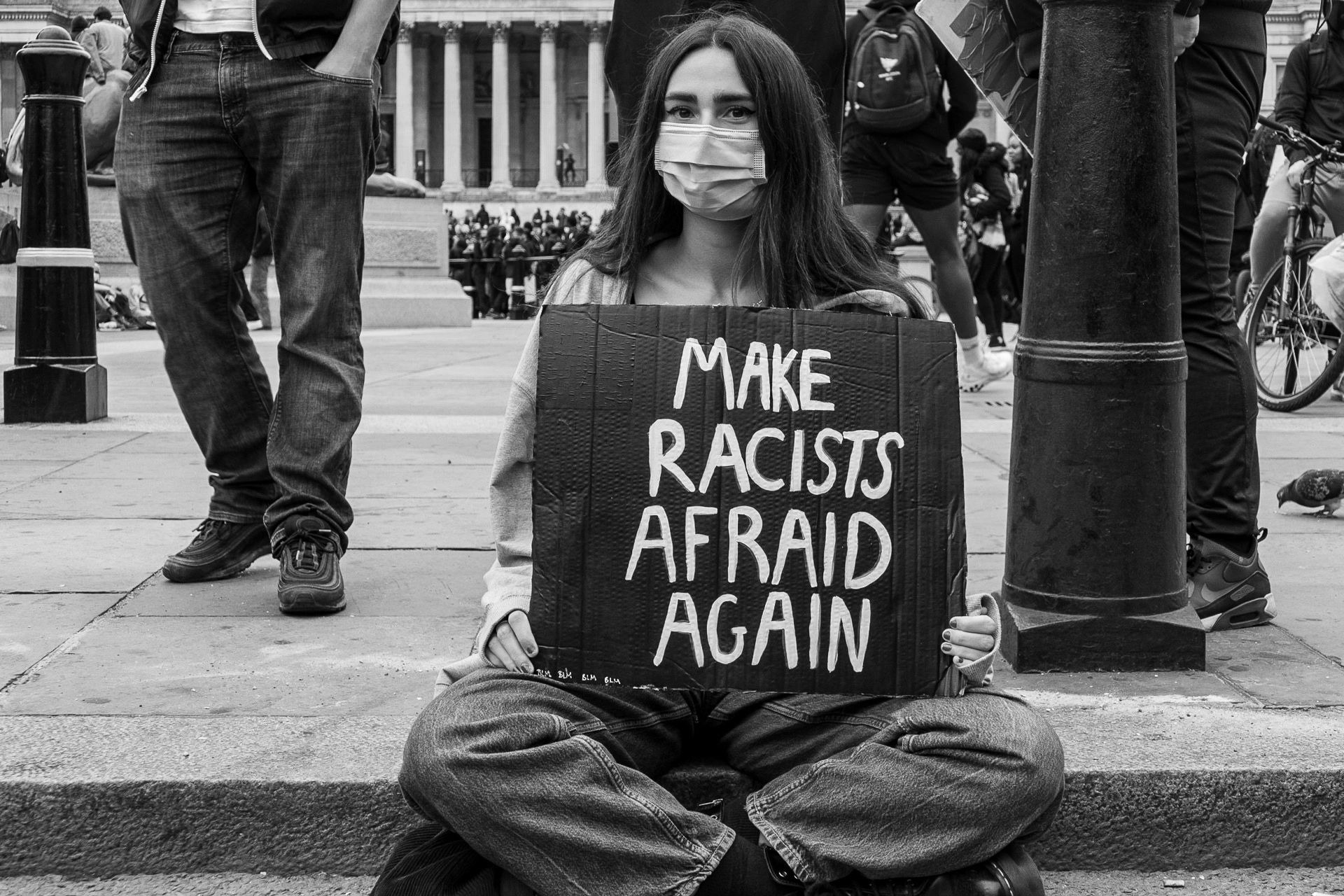 Black Lives Matter protester holding a sign against racism - Photo documentary | Leica V-Lux | 48mm f/4.0 | 1/160s | ISO 125