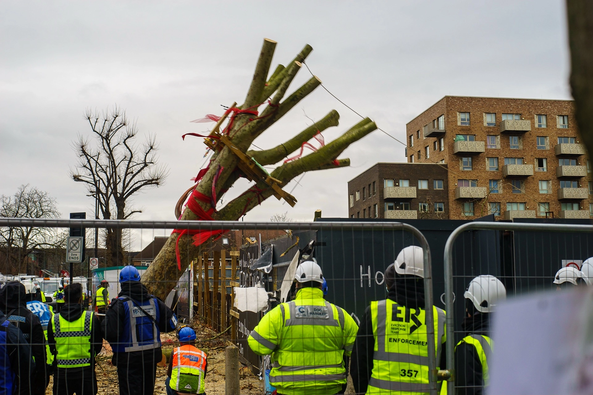 Police officers guarding the Happy Man Tree protest site in Hackney. | Sony ILCE-7 (Alpha 7) | N/A | 1/100s | ISO 125