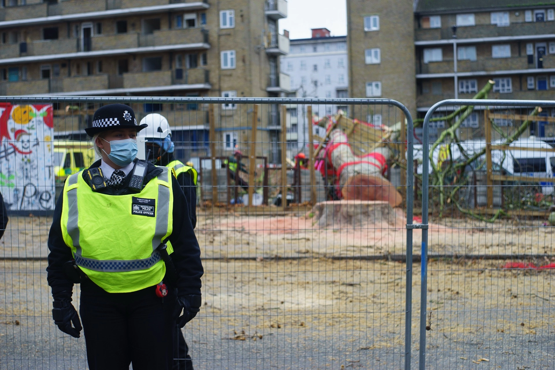 Police officer sitting and speaking with a local resident at the protest site. | Sony ILCE-7 (Alpha 7) | N/A | 1/200s | ISO 100